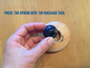 Now please press the sphere in the massage roller.